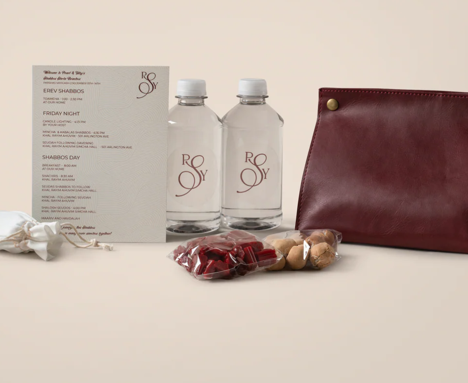 A signature welcome package with menu card, monogrammed bottles and burgundy clutch